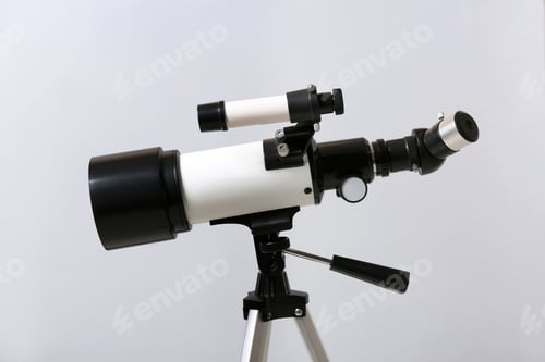 Preview: Tripod with modern telescope on light background, closeup