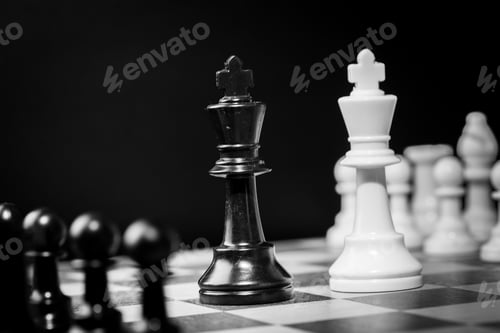 Preview: Chess game between black and white pieces on a chessboard in a dark setting