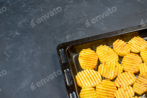 Preview: bottom half view tasty grilled potatoes on sheet pan on table with free space