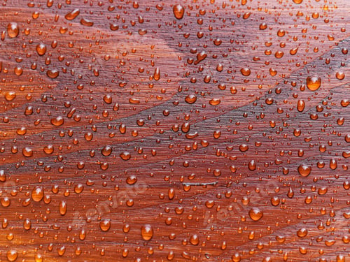 Preview: full frame natural background with rain drops on red wooden table