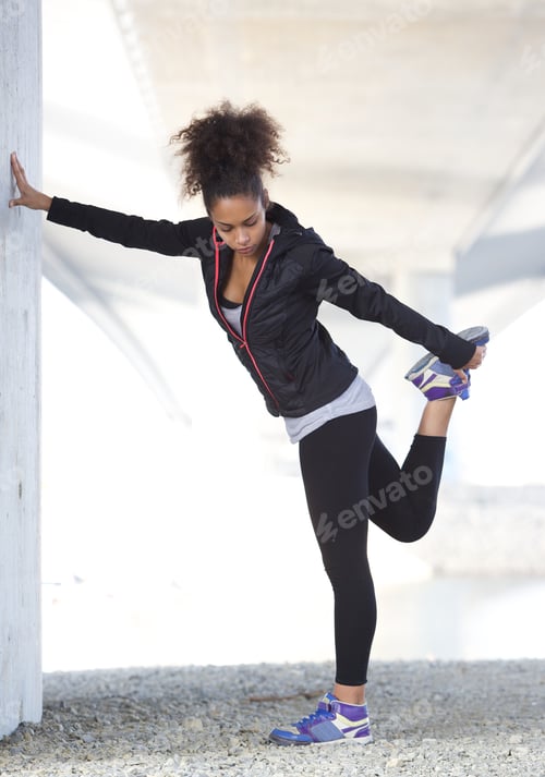 Preview: Young sports woman holding leg exercise workout