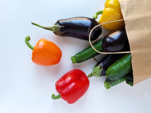 Preview: Fresh vegetables from the farmers market in a brown paper bag on white background