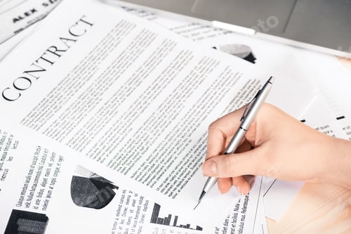 Preview: cropped view of businesswoman signing contract documents sitting at table