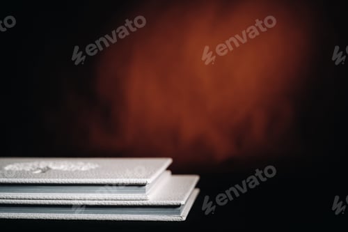 Preview: Composition of photo books in natural white leather of different sizes. The white paper on a dark
