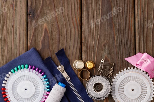 Preview: Threads and sewing accessories on brown wooden table