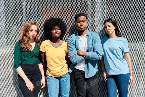 Preview: Urban Portrait of multiethnic friends looking serious at the camera in the street