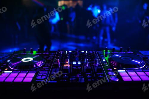 Preview: DJ console for mixing music with blurry people dancing at a nightclub party