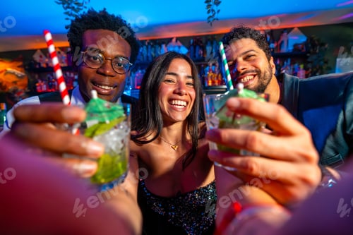 Preview: Friends toasting cocktails at pub, celebrating weekend nightlife