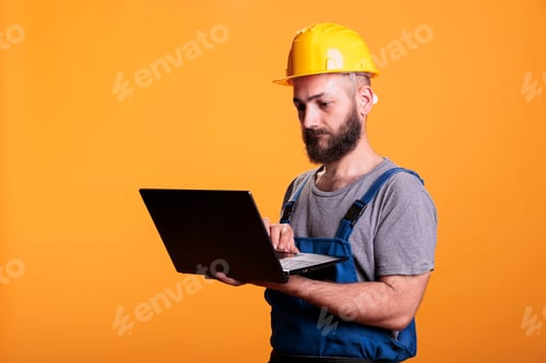Preview: Handyman using laptop to browse internet website