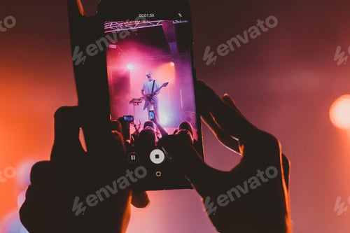 Preview: musician playing guitar and singing on stage / live concert