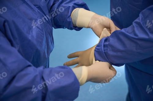 Preview: Doctors Putting On Medical Gloves in a Hospital