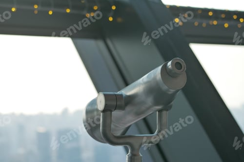 Preview: Coin-operated binoculars looking out over city ,