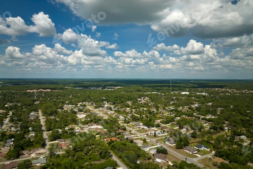 Preview: Aerial landscape view of suburban private houses between green palm trees in Florida