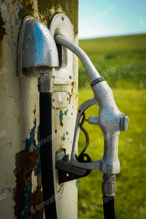 Preview: Old rustic gas pump against a blurry backdrop.