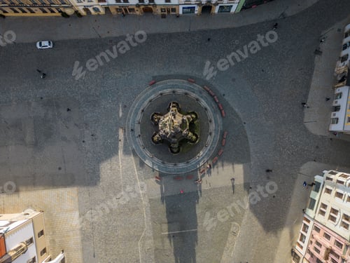 Preview: Aerial top view of a monument in the middle of a cross road in a city