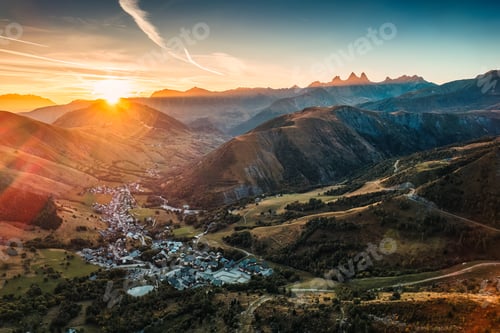 Preview: Sunrise over Arves massif among French Alps with ski town in valley during autumn