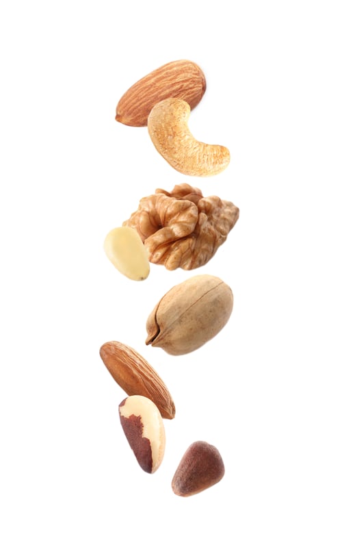 Preview: Different nuts falling on white background