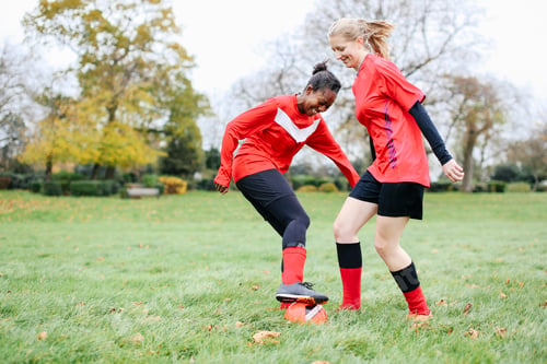 Preview: Two female soccer players practicing in park