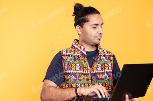 Preview: Man using laptop to do business related tasks for company