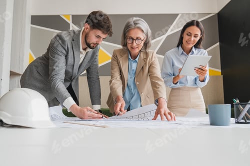 Preview: Team Discussing Architectural Plans in a Modern Office Environment