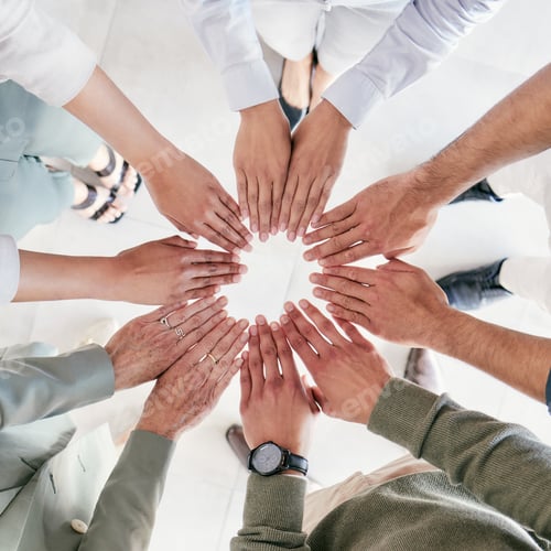 Preview: Putting her fingers to work. Shot of a group of businesspeople joining hands in solidarity.
