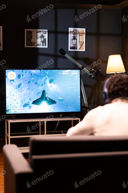 Preview: Gamer in front of widescreen smart TV watching SF videogame gameplay