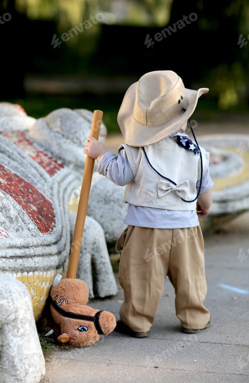 Preview: kid in a cowboy hat and with a stick in his hands