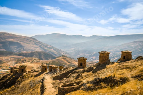 Preview: High-angle of a Ninamarca with castles and yellow grass, foggy mountains in the background