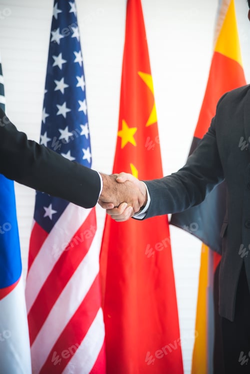 Preview: Business people shake hands, international flag background