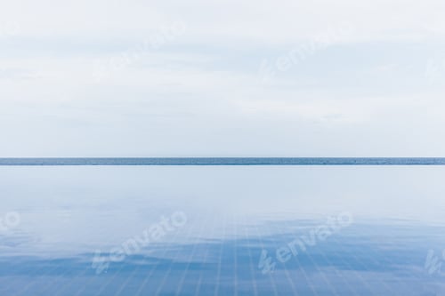 Preview: calm scene of swimming pool, ocean and sky