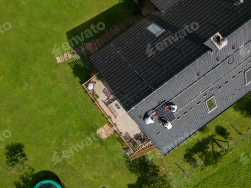 Preview: Men worker installing solar photovoltaic panels on roof, alternative energy, saving resources and