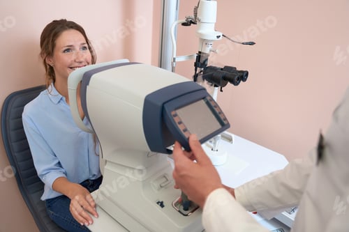 Preview: Caucasian female getting qualified examining her eyes in ophthalmology center