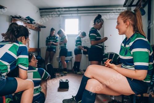 Preview: Female rugby players in a pregame locker room chat.