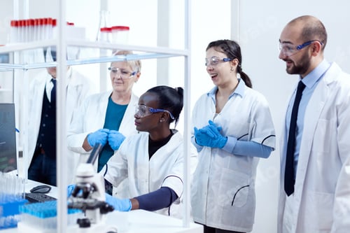 Preview: Team of scientists with diverse ethnicity analysing patient patology