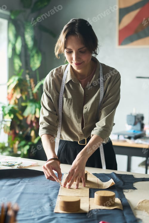 Preview: Young Adult Caucasian Woman Creating Clothing Patterns in Fashion Design Studio