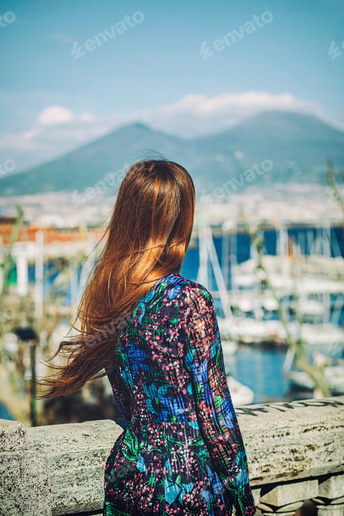 Preview: Woman with long hair enjoying the view of naples and mount vesuvius