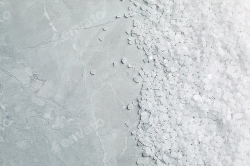 Preview: Natural sea salt on light grey marble table, top view. Space for text
