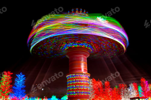 Preview: Carnival amusement park ride with swings. Spinning fair ride at night with bright color lights