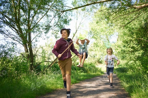 Preview: Boys running on track with sticks