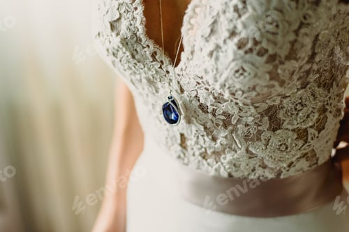 Preview: Detail of a white and elegant wedding dress.