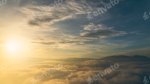 Preview: Sunset sky clouds over mountains with sea mist in the morning with colorful orange, yellow sunrise i