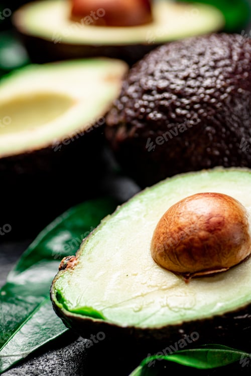 Preview: Cut ripe avocado with leaves.