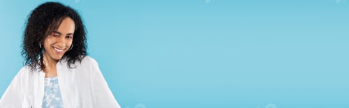 Preview: brunette african american woman winking at camera isolated on blue, banner