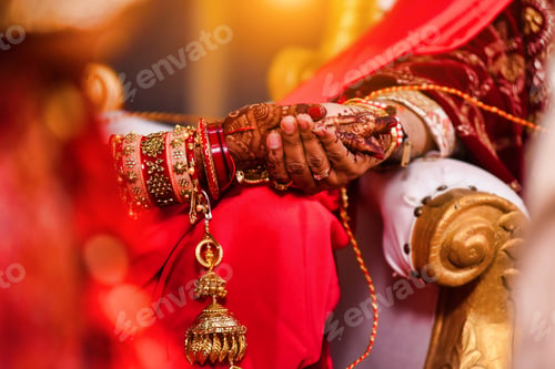 Preview: Closeup of hands with henna tattoos during an Indian traditional wedding ceremony, kanyadan ritual