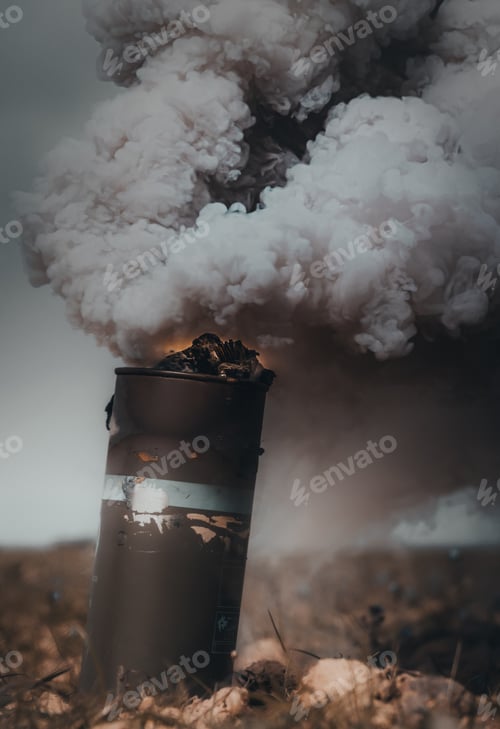 Vista previa: Vertical shot of an artillery shell on a smoky battlefield background