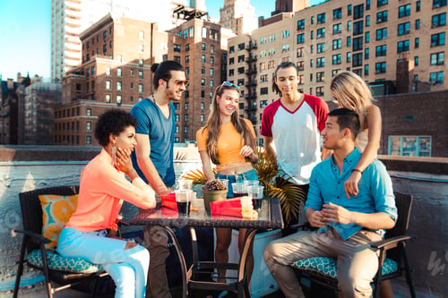 Preview: Group of friends having party on a rooftop