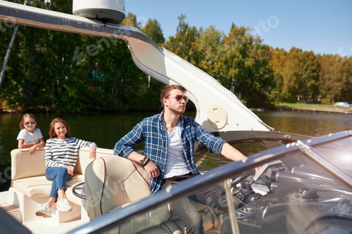 Preview: father with adorable daughter and wife resting on big boat
