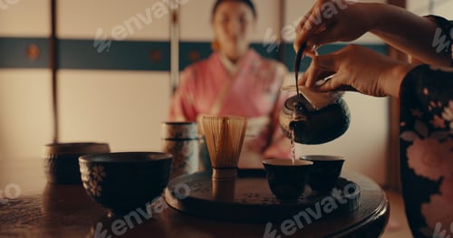 Preview: Woman pouring traditional Japanese tea with kimono, teapot and relax with mindfulness, respect and