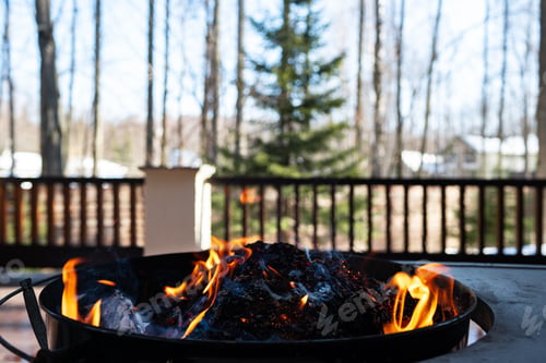 Preview: Barbecue grill with fire on open air close up