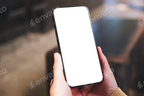 Preview: Mockup image of a woman holding and using mobile phone with blank desktop in cafe